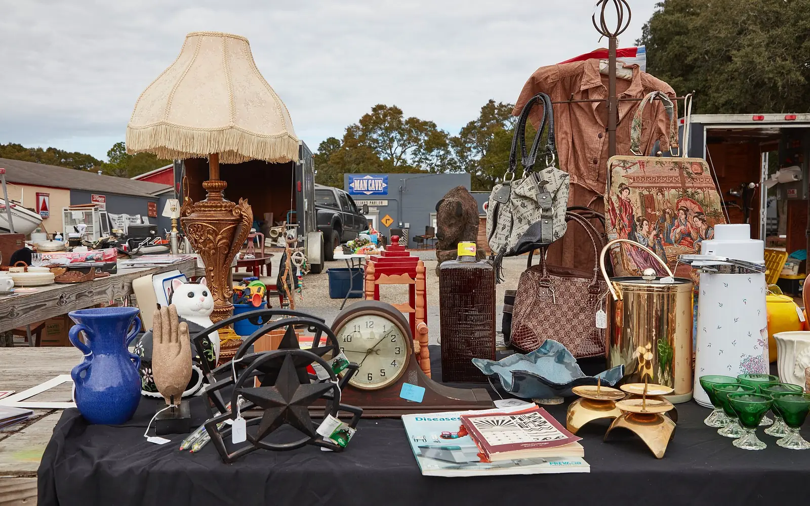 Shoppers browsing tables at a flea market